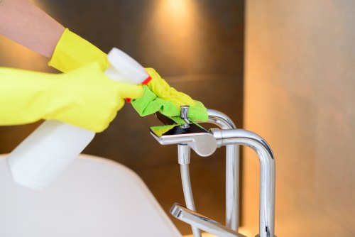 Safety-focused oven cleaning in Barnes with protective gloves