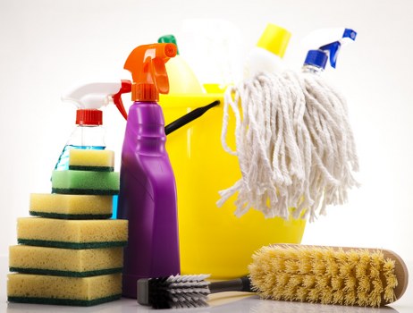 Oven cleaner working in a Barnes kitchen with careful preparation